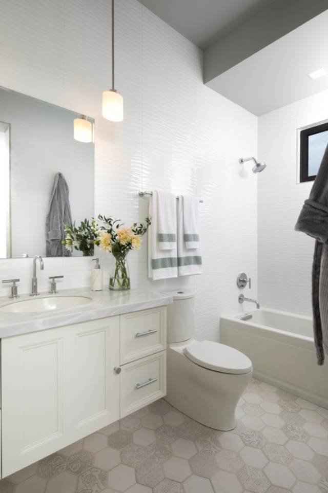 grey mosaic porcelain tile in bathroom floor with bathtub and vanity.